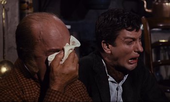 Movie still from “Mary Poppins” (1964), directed by Robert Stevenson – Two men sitting next to each other and one of them is crying; Close Up shot, High angle