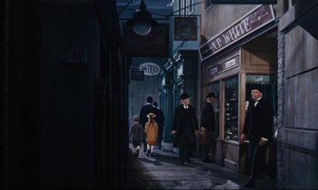 Movie still from “Mary Poppins” (1964), directed by Robert Stevenson – A group of people walking down a street at night; Extreme Wide shot, High angle