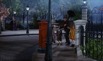Movie still from “Mary Poppins” (1964), directed by Robert Stevenson – A group of people standing next to each other on a sidewalk; Wide shot, Low angle