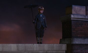 Movie still from “Mary Poppins” (1964), directed by Robert Stevenson – A young boy dressed in a suit and holding a broom; Wide shot, Low angle