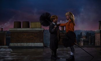 Movie still from “Mary Poppins” (1964), directed by Robert Stevenson – Two people standing next to each other holding umbrellas; Wide shot, High angle