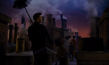 Movie still from “Mary Poppins” (1964), directed by Robert Stevenson – A statue of a man standing in front of smoke stacks; Wide shot, High angle