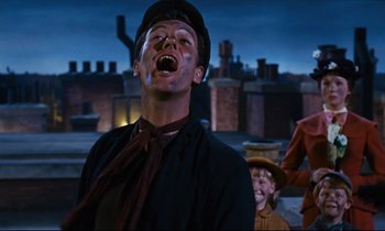 Movie still from “Mary Poppins” (1964), directed by Robert Stevenson – A man in a hat and a black shirt is laughing and looking up; Medium shot, Low angle