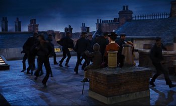 Movie still from “Mary Poppins” (1964), directed by Robert Stevenson – A group of people walking on a roof top at night; Wide shot, High angle