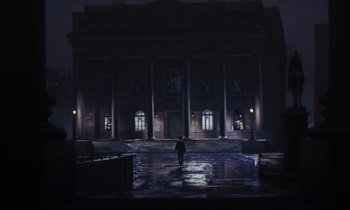 Movie still from “Mary Poppins” (1964), directed by Robert Stevenson – A person walking in front of a building at night; Extreme Wide shot, Low angle
