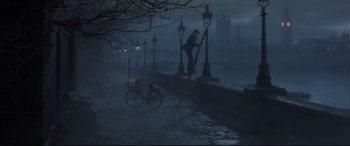 Movie still from “Mary Poppins Returns” (2018), directed by Rob Marshall – A man standing on a bridge in the dark; Extreme Wide shot, Low angle