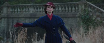 Movie still from “Mary Poppins Returns” (2018), directed by Rob Marshall – A woman in a red hat and gloves holding a knife; Medium shot, Low angle