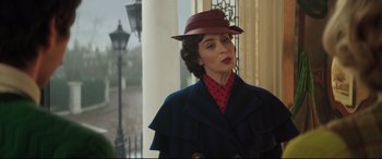 Movie still from “Mary Poppins Returns” (2018), directed by Rob Marshall – A woman wearing a red hat and a blue coat; Medium shot, Over the shoulder angle