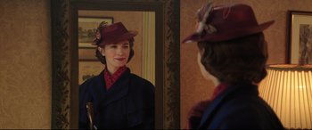Movie still from “Mary Poppins Returns” (2018), directed by Rob Marshall – A woman wearing a hat looking in a mirror; Close Up shot, Over the shoulder angle