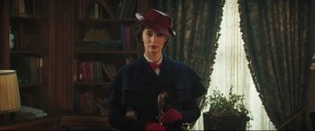 Movie still from “Mary Poppins Returns” (2018), directed by Rob Marshall – A woman wearing a red hat and a blue coat; Medium shot, Low angle