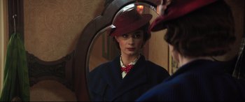 Movie still from “Mary Poppins Returns” (2018), directed by Rob Marshall – A woman in a red hat looking into a mirror; Close Up shot, Over the shoulder angle
