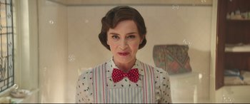 Movie still from “Mary Poppins Returns” (2018), directed by Rob Marshall – A woman in a polka dot dress and a red bow tie; Close Up shot, Low angle
