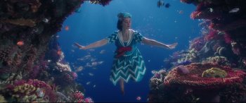 Movie still from “Mary Poppins Returns” (2018), directed by Rob Marshall – A woman in a dress floating in the ocean; Wide shot, High angle