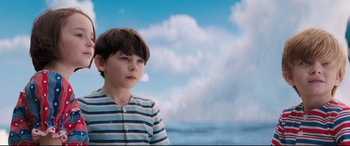 Movie still from “Mary Poppins Returns” (2018), directed by Rob Marshall – A boy in a striped shirt looking at the camera; Medium shot, High angle