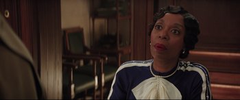 Movie still from “Mary Poppins Returns” (2018), directed by Rob Marshall – An older woman sitting in front of a wooden chair; Close Up shot, Over the shoulder angle