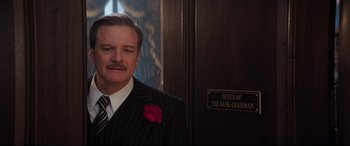 Movie still from “Mary Poppins Returns” (2018), directed by Rob Marshall – A person wearing a suit and tie; Medium shot, Low angle