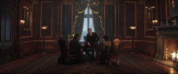 Movie still from “Mary Poppins Returns” (2018), directed by Rob Marshall – A group of people sitting in a room with a window; Wide shot, Low angle