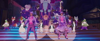 Movie still from “Mary Poppins Returns” (2018), directed by Rob Marshall – A couple of people that are standing in front of a stage; Wide shot, Low angle