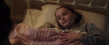 Movie still from “Mary Poppins Returns” (2018), directed by Rob Marshall – A little girl laying in bed with a teddy bear; Close Up shot, High angle