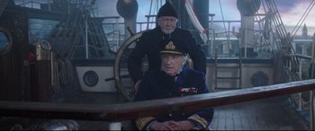 Movie still from “Mary Poppins Returns” (2018), directed by Rob Marshall – Two men on a boat one of them is sitting on the steering wheel; Medium shot, High angle