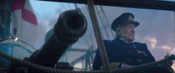 Movie still from “Mary Poppins Returns” (2018), directed by Rob Marshall – A man in a blue uniform and a hat; Medium shot, Low angle