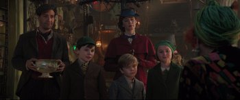 Movie still from “Mary Poppins Returns” (2018), directed by Rob Marshall – A group of people standing next to each other in a room; Medium shot, Low angle