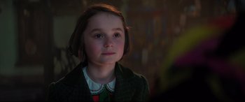 Movie still from “Mary Poppins Returns” (2018), directed by Rob Marshall – A young girl in a green coat looking at the camera; Close Up shot, Over the shoulder angle