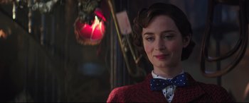 Movie still from “Mary Poppins Returns” (2018), directed by Rob Marshall – A woman in a red jacket and a bow tie; Close Up shot, Over the shoulder angle