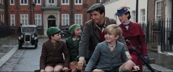 Movie still from “Mary Poppins Returns” (2018), directed by Rob Marshall – A group of children sitting next to each other; Medium shot, Over the shoulder angle