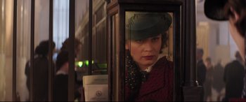 Movie still from “Mary Poppins Returns” (2018), directed by Rob Marshall – A woman in a hat is looking out of a window; Close Up shot, Over the shoulder angle