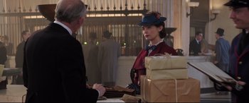 Movie still from “Mary Poppins Returns” (2018), directed by Rob Marshall – A man and a woman standing next to each other at a table; Medium shot, Over the shoulder angle