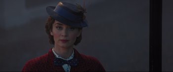 Movie still from “Mary Poppins Returns” (2018), directed by Rob Marshall – A woman wearing a hat and a bow tie; Close Up shot, Over the shoulder angle