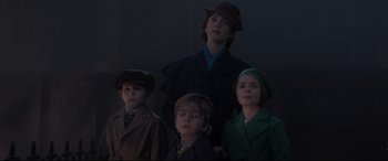 Movie still from “Mary Poppins Returns” (2018), directed by Rob Marshall – A group of people standing next to each other; Medium shot, Low angle