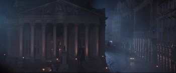 Movie still from “Mary Poppins Returns” (2018), directed by Rob Marshall – A person standing in front of a building with candles; Extreme Wide shot, Low angle