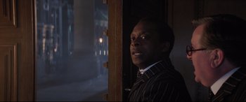 Movie still from “Mary Poppins Returns” (2018), directed by Rob Marshall – A man standing in front of an open door; Close Up shot, Over the shoulder angle