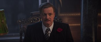 Movie still from “Mary Poppins Returns” (2018), directed by Rob Marshall – A man wearing a suit and tie in a dark room; Close Up shot, Low angle