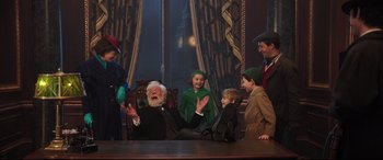Movie still from “Mary Poppins Returns” (2018), directed by Rob Marshall – A group of people sitting around a table; Medium shot, Over the shoulder angle
