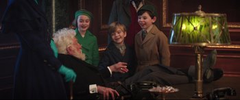 Movie still from “Mary Poppins Returns” (2018), directed by Rob Marshall – A group of children sitting next to each other in a room; Medium shot, Over the shoulder angle