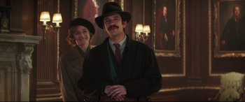 Movie still from “Mary Poppins Returns” (2018), directed by Rob Marshall – A man and a woman standing next to each other in a room; Medium shot, Over the shoulder angle