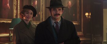 Movie still from “Mary Poppins Returns” (2018), directed by Rob Marshall – A man with a mustache wearing a hat and a suit; Medium shot, Low angle