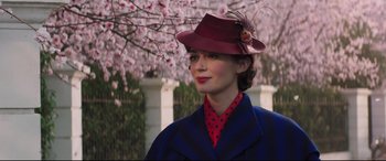 Movie still from “Mary Poppins Returns” (2018), directed by Rob Marshall – A woman wearing a red hat and a blue coat; Close Up shot, Low angle