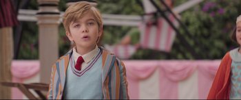 Movie still from “Mary Poppins Returns” (2018), directed by Rob Marshall – A young boy wearing a suit and a tie; Medium shot, Over the shoulder angle