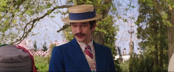 Movie still from “Mary Poppins Returns” (2018), directed by Rob Marshall – A man in a straw hat and a blue suit; Close Up shot, Over the shoulder angle
