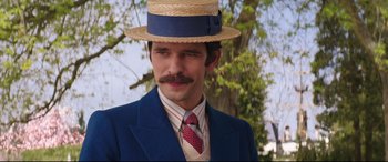 Movie still from “Mary Poppins Returns” (2018), directed by Rob Marshall – A man in a straw hat and a blue suit; Close Up shot, Over the shoulder angle
