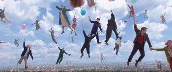 Movie still from “Mary Poppins Returns” (2018), directed by Rob Marshall – A group of people that are in the air with balloons; Wide shot, Overhead angle