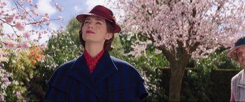 Movie still from “Mary Poppins Returns” (2018), directed by Rob Marshall – A woman wearing a red hat and a blue coat; Close Up shot, Low angle