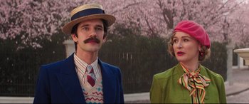 Movie still from “Mary Poppins Returns” (2018), directed by Rob Marshall – A man and a woman standing next to each other; Medium shot, Low angle