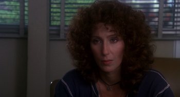 Movie still from “Mask” (1985), directed by Peter Bogdanovich – A person with curly brown hair; Close Up shot, Over the shoulder angle