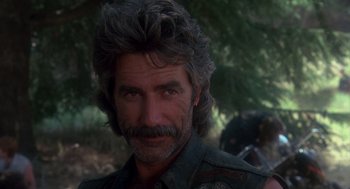 Movie still from “Mask” (1985), directed by Peter Bogdanovich – A person with a beard; Close Up shot, Over the shoulder angle