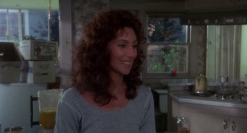 Movie still from “Mask” (1985), directed by Peter Bogdanovich – A person with long curly hair; Close Up shot, Over the shoulder angle